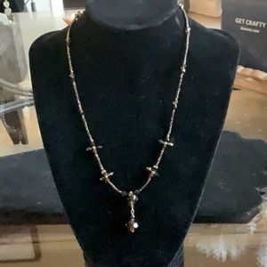 An amber bead & crystal necklace with a little drop that really reflects light